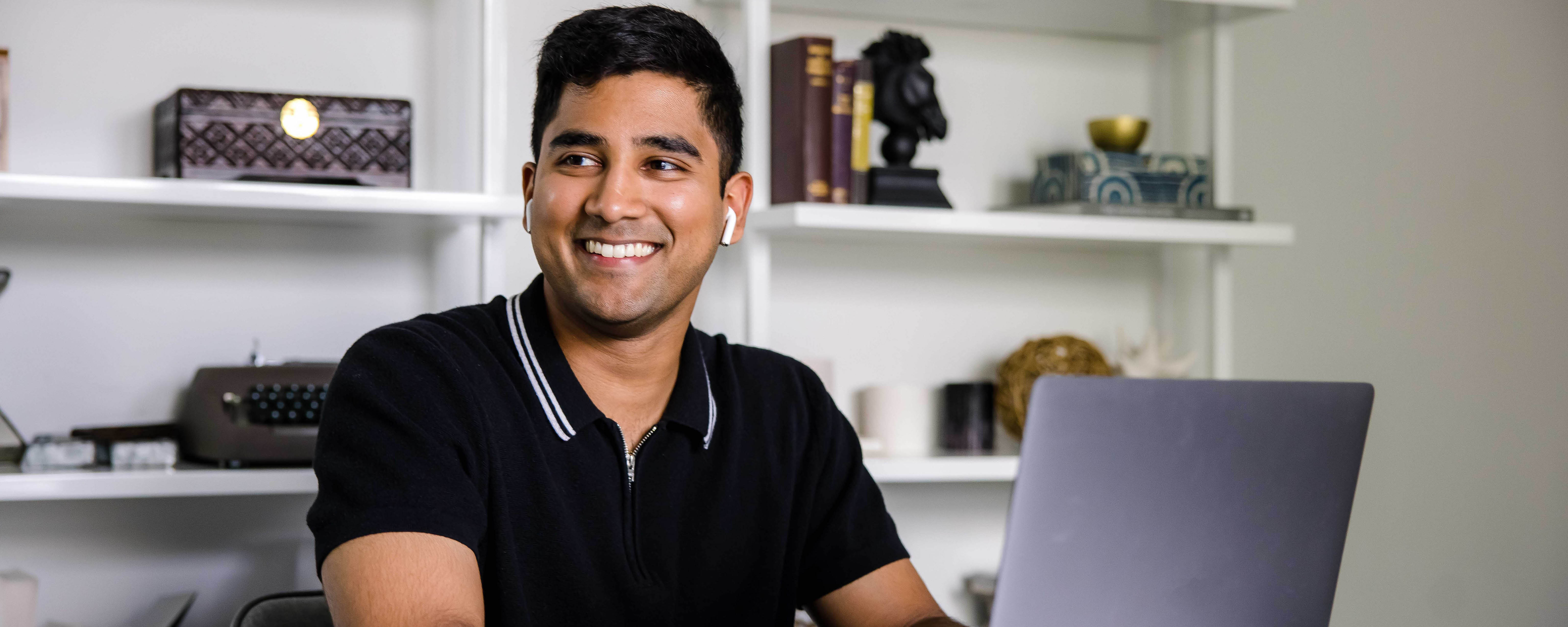 A Capital One associate sits at home and works on his laptop