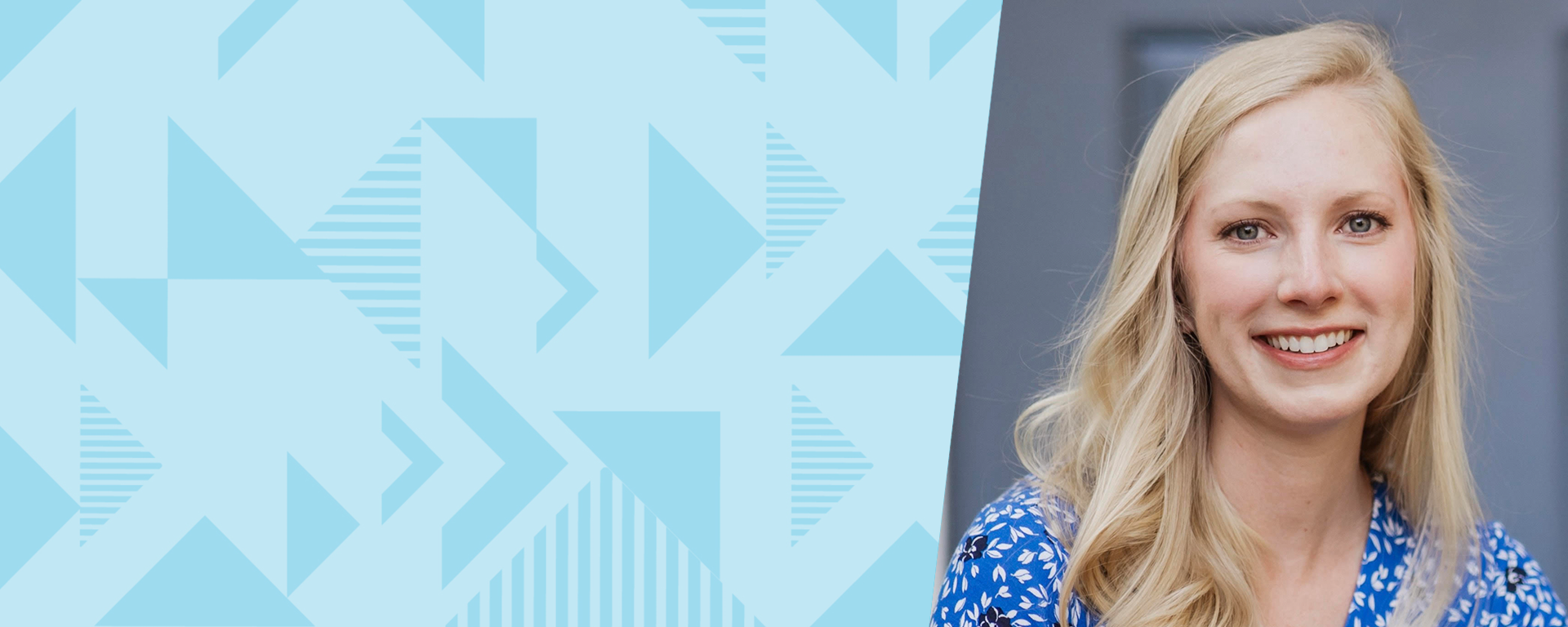 Capital One associate Sarah Ann smiles in front of gray background wearing a blue shirt