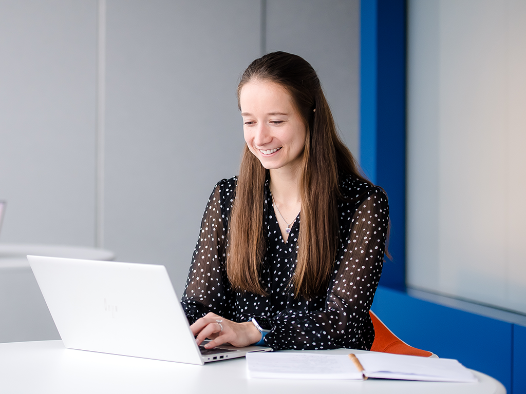 Capital One Strategy Consulting associate works on her laptop
